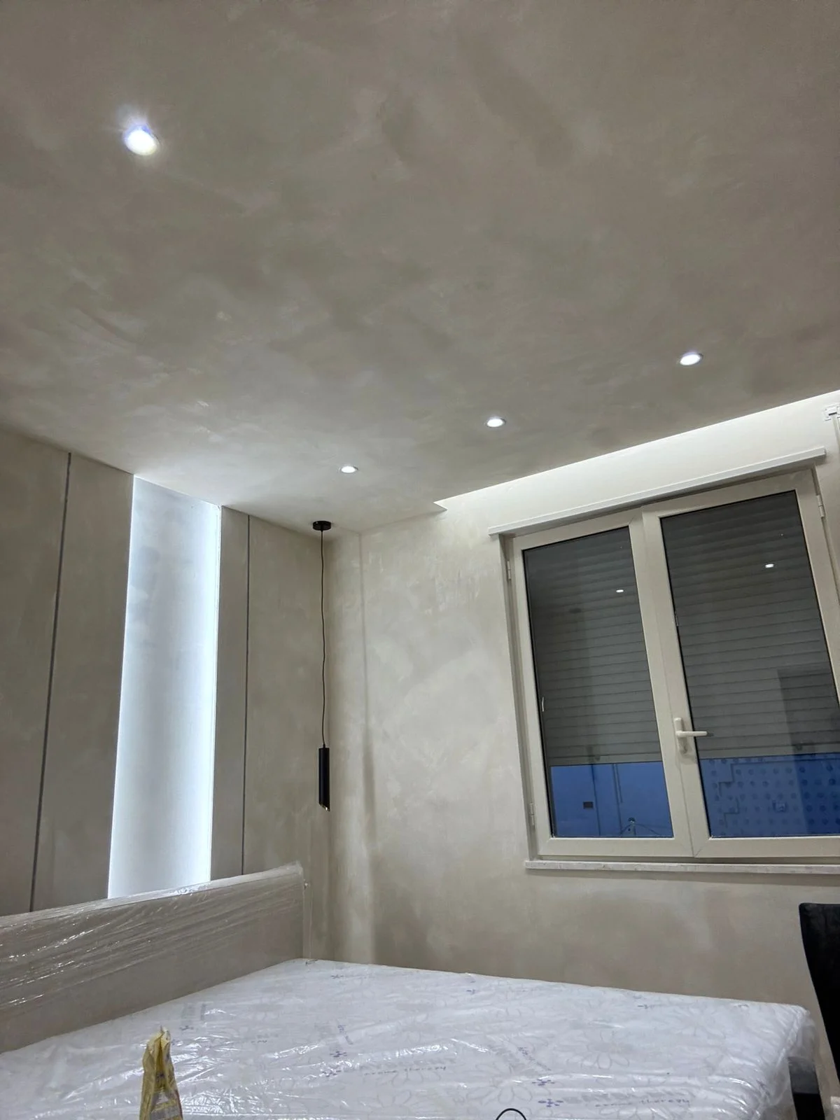 Bedroom with gypsum ceiling, spotlights and LED cove lighting, relaxing atmosphere