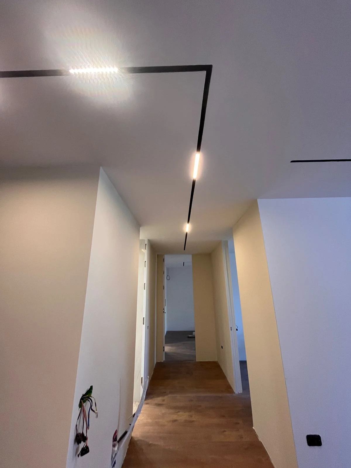 Geometric linear LED track lighting in gypsum ceiling, minimalist modern style